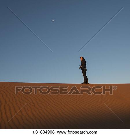 Woman standing on Erg Chegaga Dunes in Sahara Desert, Morocco View Large Photo Image Stock Photo - Woman standing on Erg Chegaga Dunes in Sahara Desert, Morocco. Fotosearch