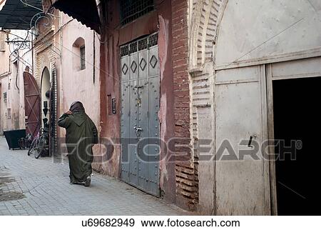 Stock Photo - Woman walking in an alley, Marrakesh, Morocco. Fotosearch