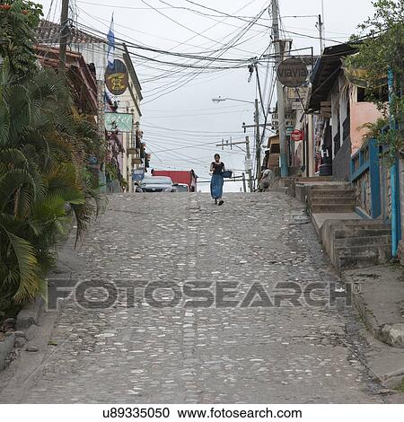 Woman walking on a street, Barrio El Centro, Copan, Copan Ruinas, Honduras View Large Photo Image Stock Image - Woman walking on a street, Barrio El Centro, Copan, Copan Ruinas, Honduras. Fotosearch