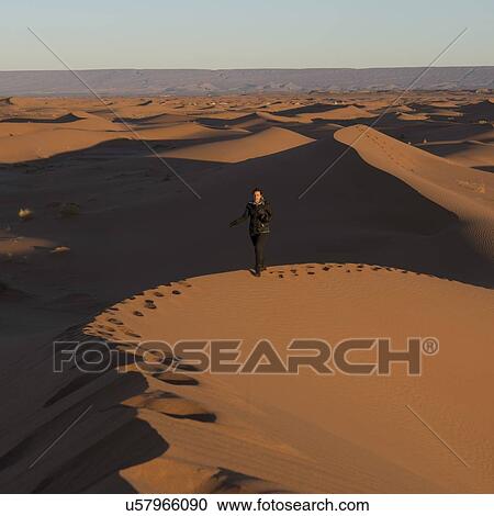 Woman walking on Erg Chegaga Dunes in Sahara Desert, Morocco View Large Photo Image Stock Image - Woman walking on Erg Chegaga Dunes in Sahara Desert, Morocco. Fotosearch