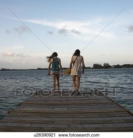 Woman with her daughter standing on a pier and looking at sea, Utila Island, Bay Islands, Honduras View Large Photo Image Stock Image - Woman with her daughter standing on a pier and looking at sea, Utila Island, Bay Islands, Honduras. Fotosearch