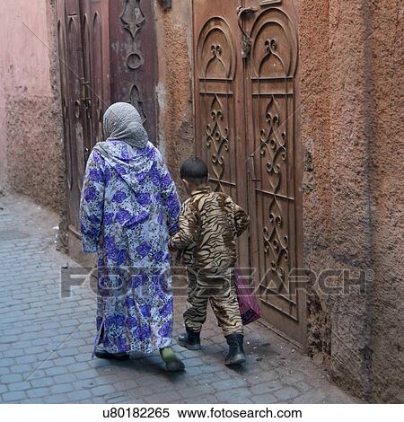 Stock Photography - Woman with her son walking on a street, Medina, Marrakesh, Morocco. Fotosearch