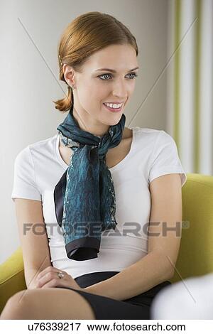 Beautiful young businesswoman sitting at lobby View Large Photo Image Stock Photo - Beautiful young businesswoman sitting at lobby. Fotosearch