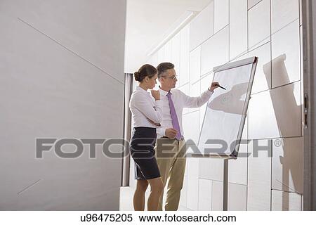 Business colleagues planning for presentation in office View Large Photo Image Stock Photography - Business colleagues planning for presentation in office. Fotosearch