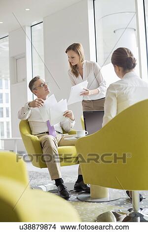 Business colleagues working at office lobby View Large Photo Image Picture - Business colleagues working at office lobby. Fotosearch