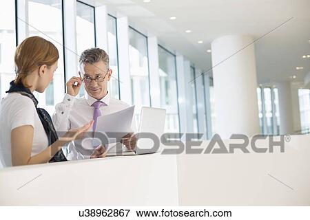 Business coworkers discussing work in office View Large Photo Image Stock Photo - Business coworkers discussing work in office. Fotosearch