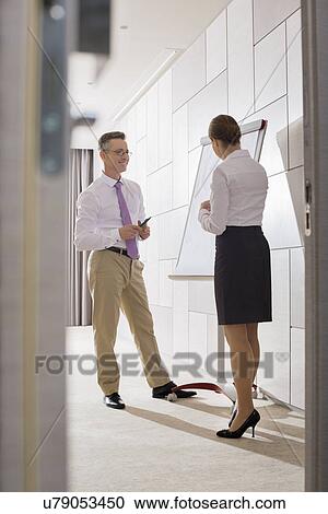 Business people preparing for presentation in office View Large Photo Image Stock Image - Business people preparing for presentation in office. Fotosearch