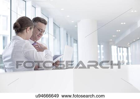 Business people working at railing in office View Large Photo Image Stock Photo - Business people working at railing in office. Fotosearch