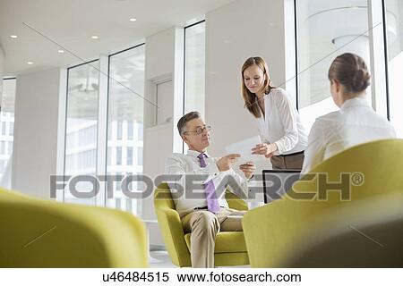 Business people working in office lobby View Large Photo Image Stock Photography - Business people working in office lobby. Fotosearch