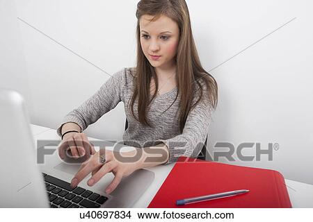 Businesswoman using laptop at office desk View Large Photo Image Picture - Businesswoman using laptop at office desk. Fotosearch