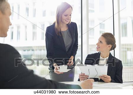 Businesswomen working at cafeteria View Large Photo Image Stock Image - Businesswomen working at cafeteria. Fotosearch