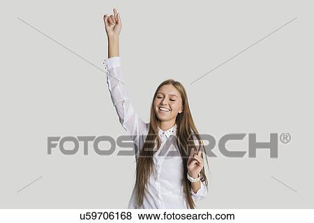 Cheerful woman dancing against white background View Large Photo Image Stock Photo - Cheerful woman dancing against white background. Fotosearch