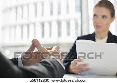 Cropped image of businessman in meeting with colleague at office cafe View Large Photo Image Stock Image - Cropped image of businessman in meeting with colleague at office cafe. Fotosearch