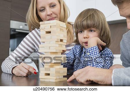 Family playing with wooden blocks at home View Large Photo Image Stock Photograph - Family playing with wooden blocks at home. Fotosearch