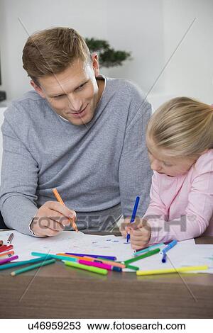 Father and daughter drawing together at home View Large Photo Image Stock Image - Father and daughter drawing together at home. Fotosearch