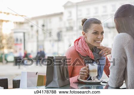Stock Photo - Female friends at sidewalk cafe. Fotosearch