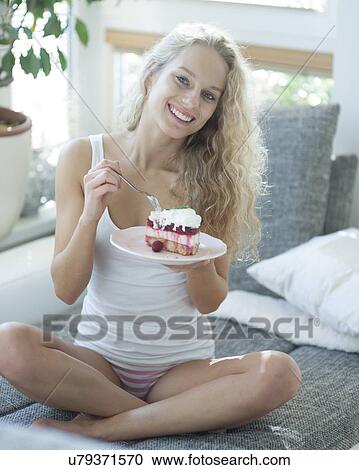 Full length portrait of woman having raspberry cake on sofa View Large Photo Image Stock Image - Full length portrait of woman having raspberry cake on sofa. Fotosearch
