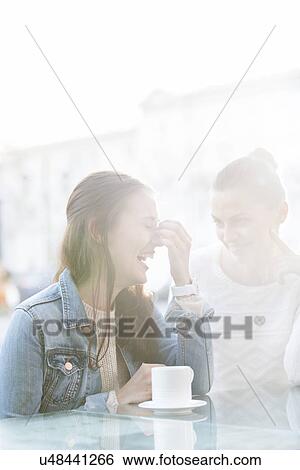 Happy women at sidewalk cafe during winter View Large Photo Image Stock Photograph - Happy women at sidewalk cafe during winter. Fotosearch