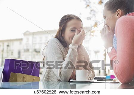 Happy women gossiping at outdoor cafe View Large Photo Image Stock Photograph - Happy women gossiping at outdoor cafe. Fotosearch