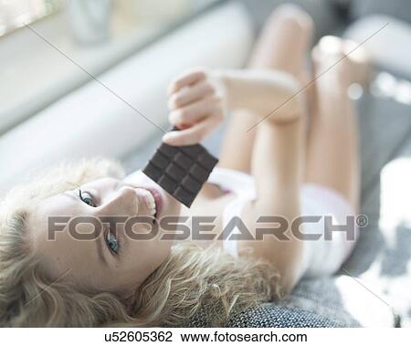 High angle portrait of woman having chocolate bar View Large Photo Image Stock Image - High angle portrait of woman having chocolate bar. Fotosearch