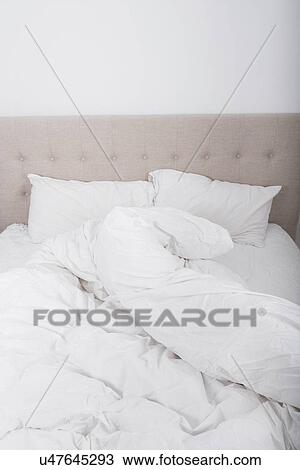 Stock Image - Messy bed in bedroom. Fotosearch