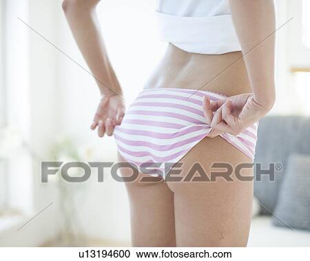 Mid section of woman wearing oversized panty View Large Photo Image Stock Image - Mid section of woman wearing oversized panty. Fotosearch