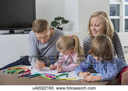 Parents with children drawing together at home View Large Photo Image Stock Photography - Parents with children drawing together at home. Fotosearch