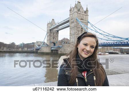 Portrait of beautiful young woman standing in front of tower bridge, London, UK View Large Photo Image Stock Image - Portrait of beautiful young woman standing in front of tower bridge, London, UK. Fotosearch