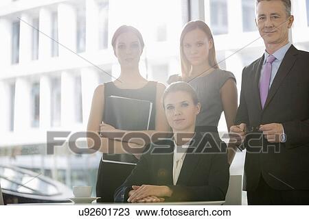 Portrait of confident business people in office cafeteria View Large Photo Image Stock Image - Portrait of confident business people in office cafeteria. Fotosearch