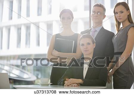 Stock Photo - Portrait of confident business team in office cafeteria. Fotosearch