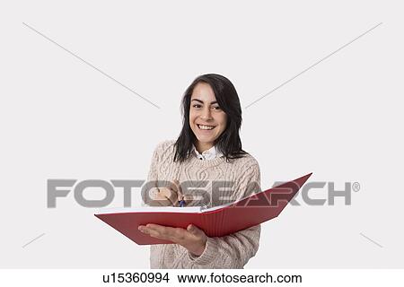 Portrait of happy businesswoman with book and pen over white background View Large Photo Image Picture - Portrait of happy businesswoman with book and pen over white background. Fotosearch