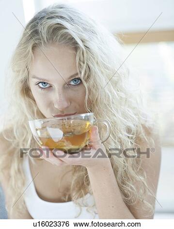 Portrait of sensuous woman drinking herbal tea in house View Large Photo Image Stock Photograph - Portrait of sensuous woman drinking herbal tea in house. Fotosearch