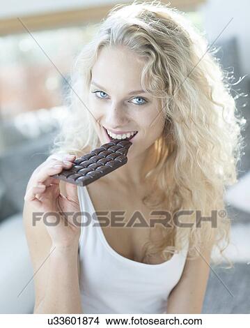 Portrait of sensuous woman eating candy bar View Large Photo Image Picture - Portrait of sensuous woman eating candy bar. Fotosearch