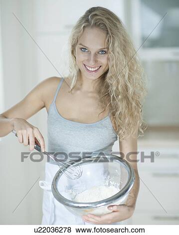 Portrait of woman mixing cookie batter in kitchen View Large Photo Image Stock Photo - Portrait of woman mixing cookie batter in kitchen. Fotosearch