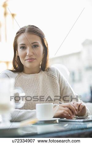 Stock Photo - Portrait of young woman at sidewalk cafe. Fotosearch