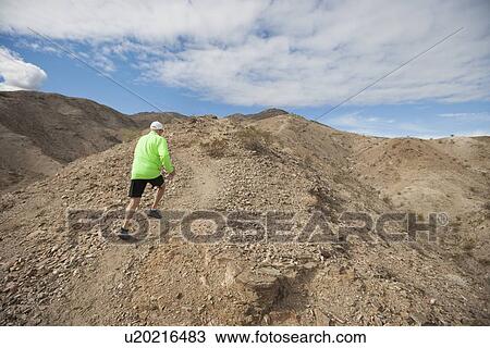 Rear view of senior man jogging on mountain View Large Photo Image Stock Image - Rear view of senior man jogging on mountain. Fotosearch