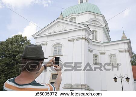 Rear view of young man photographing St. Casimir Church, Warsaw, Poland View Large Photo Image Stock Image - Rear view of young man photographing St. Casimir Church, Warsaw, Poland. Fotosearch