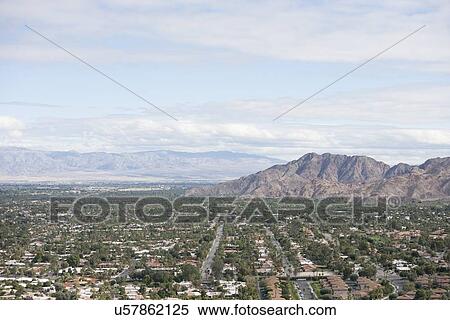 Residential district and mountains against cloudy sky View Large Photo Image Stock Photography - Residential district and mountains against cloudy sky. Fotosearch