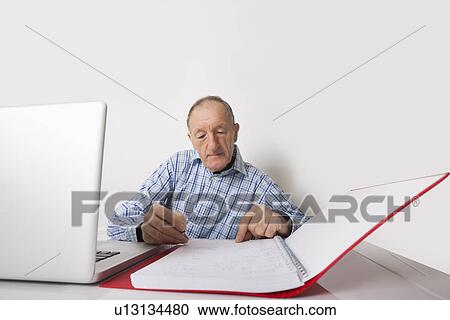 Senior businessman working at office desk View Large Photo Image Stock Image - Senior businessman working at office desk. Fotosearch