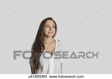 Thoughtful teenage girl against gray background View Large Photo Image Picture - Thoughtful teenage girl against gray background. Fotosearch