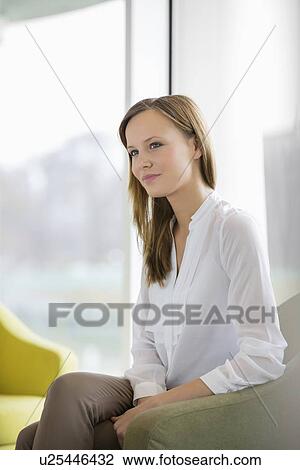 Thoughtful young businesswoman in office lobby View Large Photo Image Stock Image - Thoughtful young businesswoman in office lobby. Fotosearch