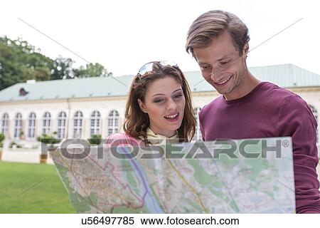 Young tourist couple with map against building View Large Photo Image Stock Photography - Young tourist couple with map against building. Fotosearch