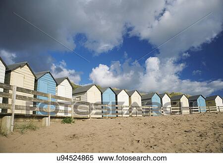 A row of blue and white beach huts, Bude, Cornwall, UK View Large Photo Image Stock Photography - A row of blue and white beach huts, Bude, Cornwall, UK. Fotosearch