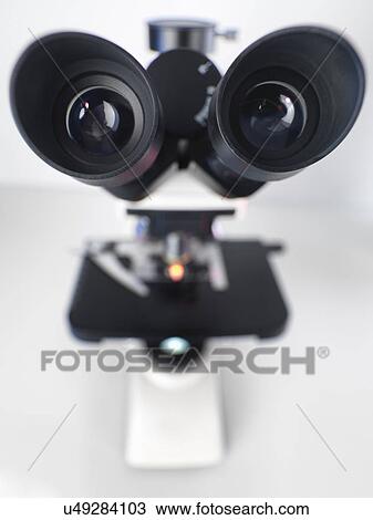 Stock Image - A view down the eye piece of a upright compound microscope. Fotosearch
