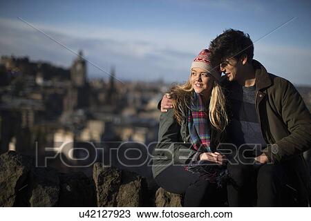 A young couple hug on Calton Hill with the background of the city of Edinburgh, capital of Scotland View Large Photo Image Stock Image - A young couple hug on Calton Hill with the background of the city of Edinburgh, capital of Scotland. Fotosearch