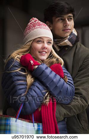 Stock Image - A young couple pose for a portrait whilst out shopping in Edinburgh, Scotland. Fotosearch