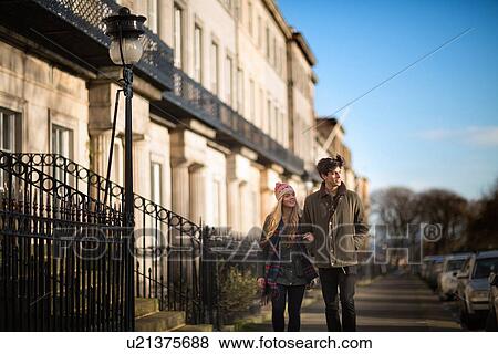 Stock Photo - A young couple walk on Regent Terrace in Edinburgh Scotland. Fotosearch