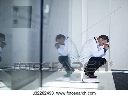 Anxious and overworked senior male doctor View Large Photo Image Stock Image - Anxious and overworked senior male doctor. Fotosearch