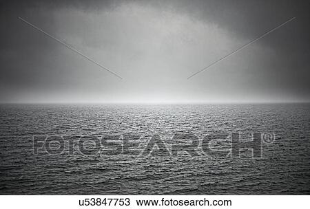 Stock Image - Black and white seascape with stormy sky. Fotosearch