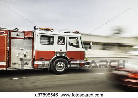 Stock Photograph - Blurred motion shot of speeding fire engine. Fotosearch